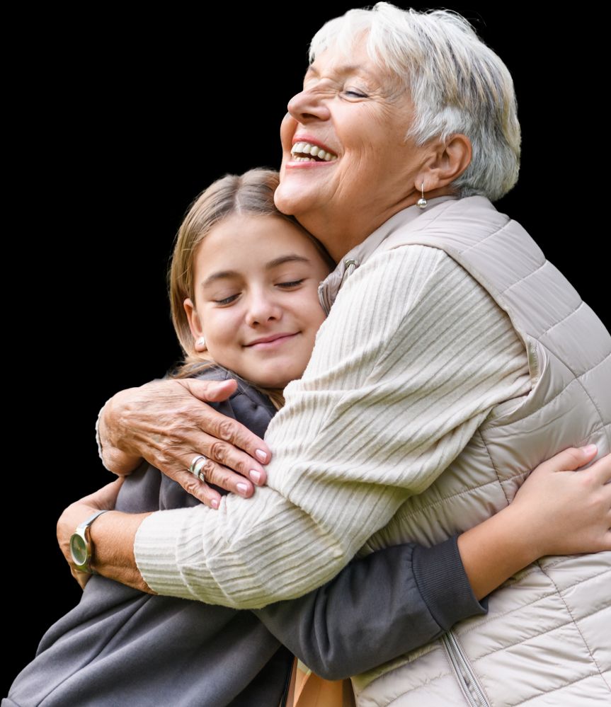 An older lady hugging her granddaughter